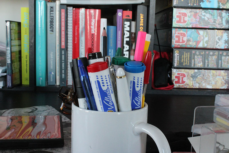 Bunch of markers and pens in a mug, shot with F29